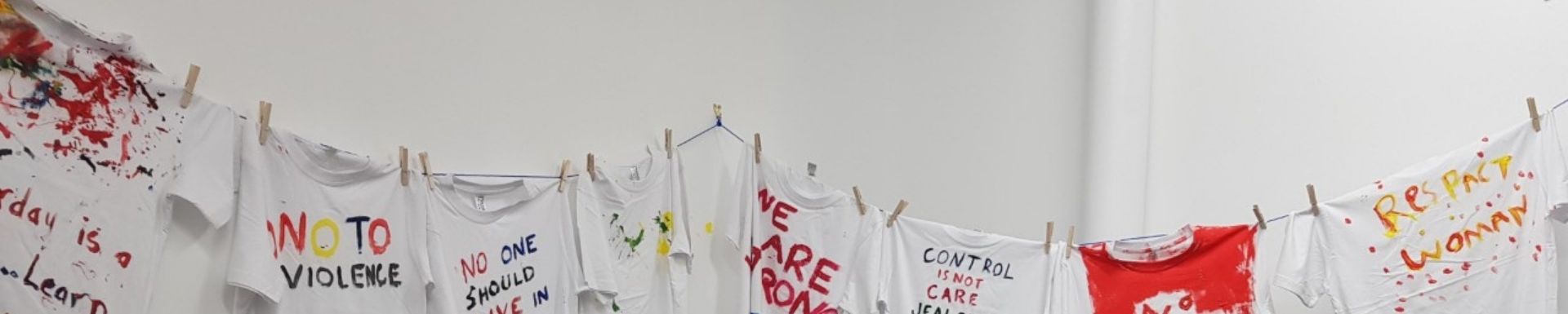 clothes line displaying tshirts with anti-violence messages