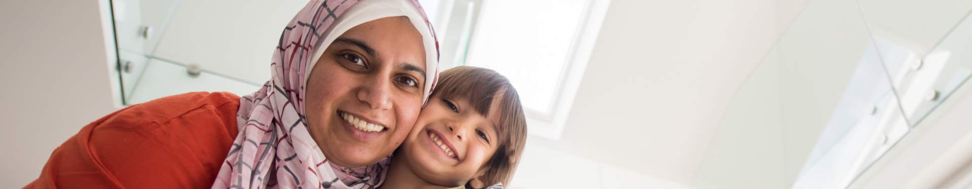 Woman with headscarf and child smiling